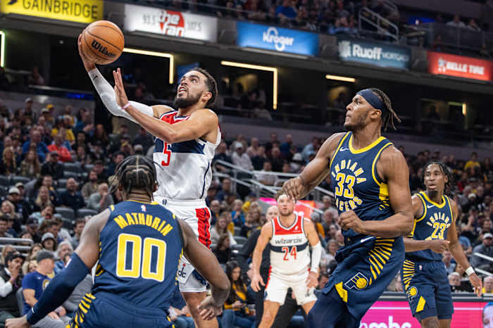 Washington Wizards guard Tyus Jones (5) shoots the ball while Indiana Pacers guard Bennedict Mathurin (00) defends in the second quarter at Gainbridge Fieldhouse.